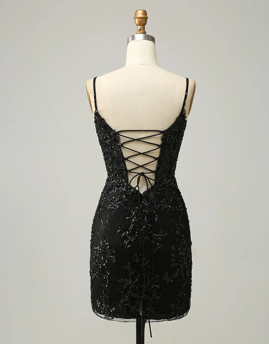 Side view of a woman wearing a black sequin mini dress.