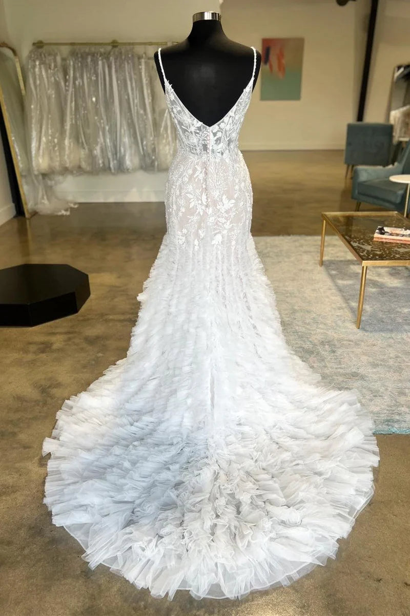 Full length view of a trumpet wedding dress with spaghetti straps.