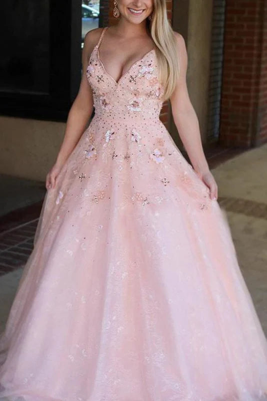 Elegant formal gown with spaghetti straps, appliques, and beading.