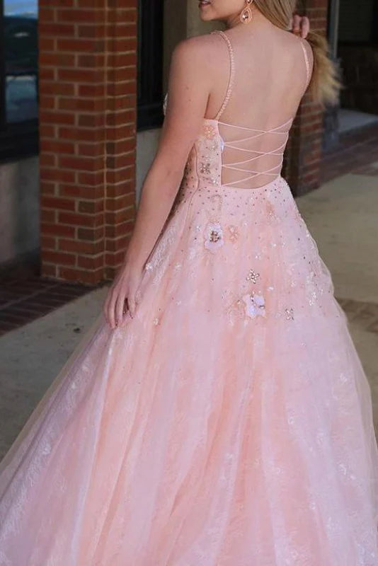 Back view of the formal gown showcasing intricate beading and flowing skirt.