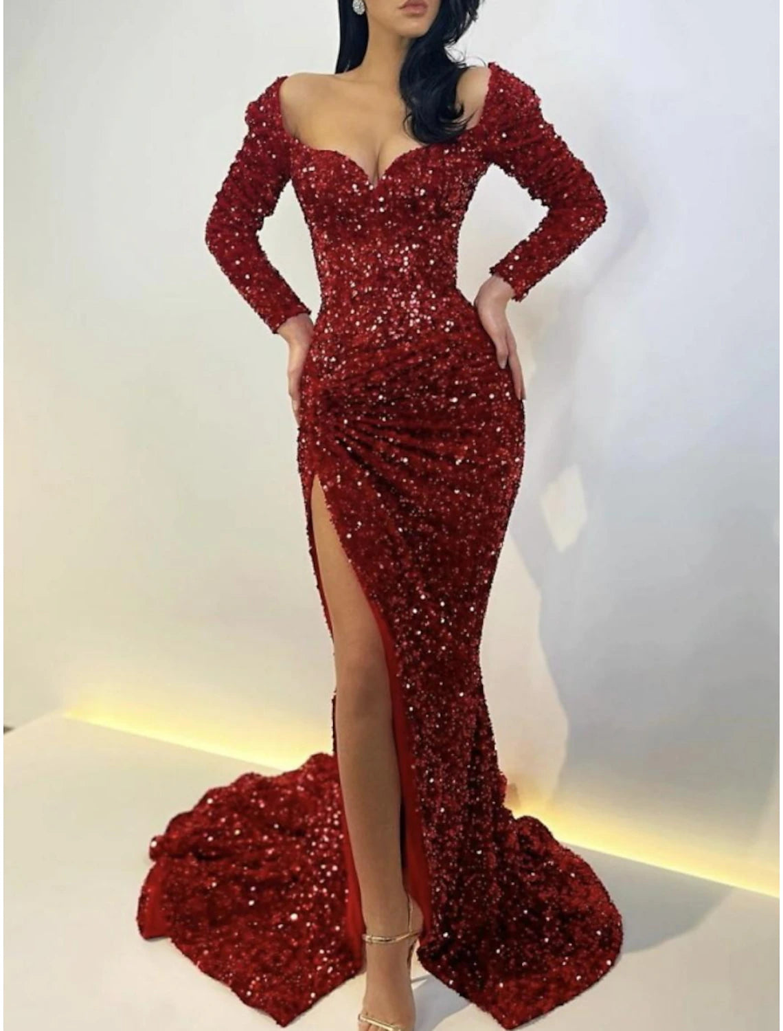Back view of the sequined mermaid gown, showing the sweep train.