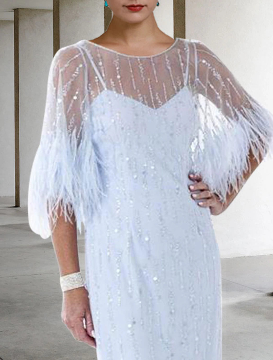 Sheath Mother of the Bride dress with intricate feather, beading, and sequin details.