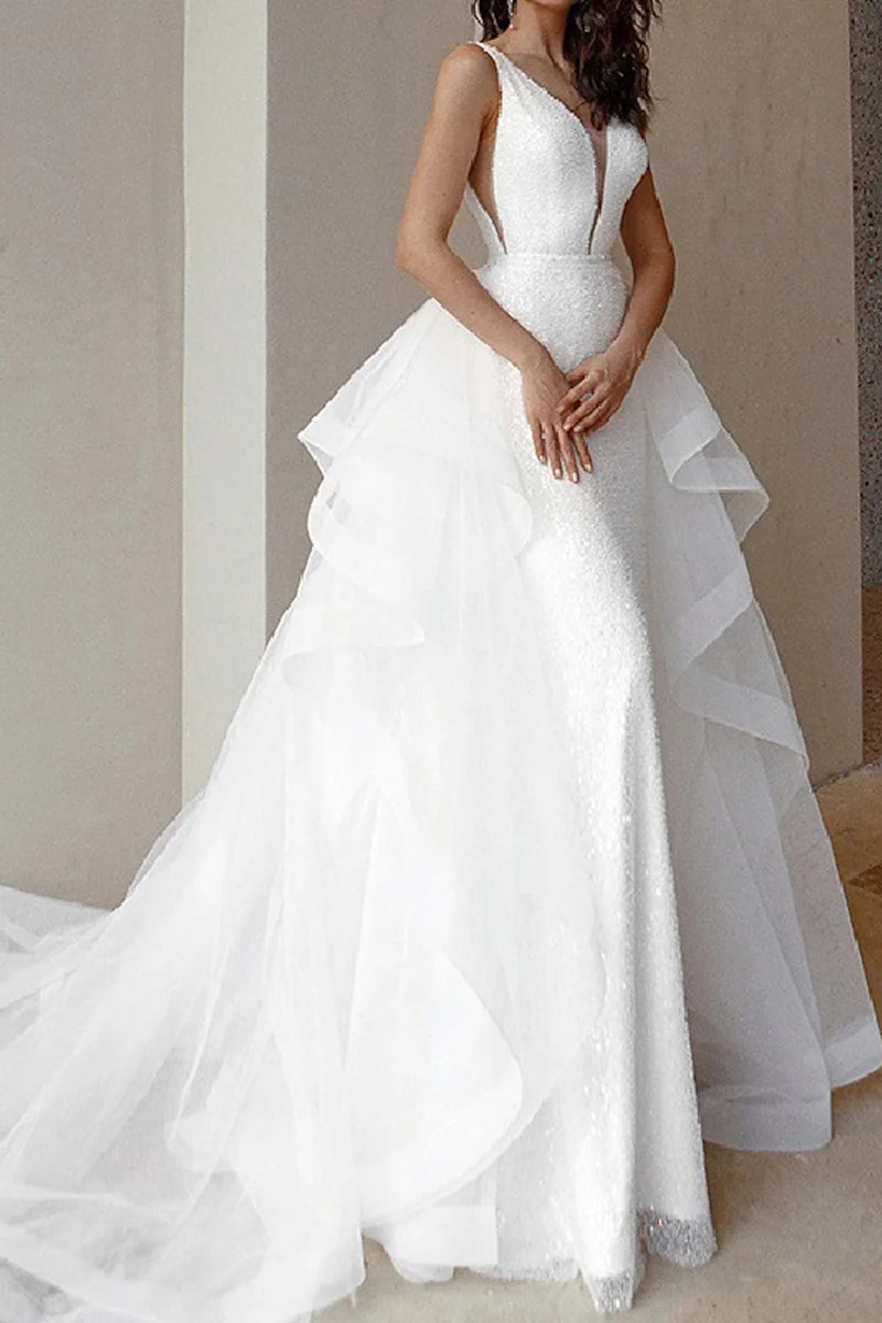 Woman wearing an elegant sparkling V-neck sleeveless formal dress, front view.