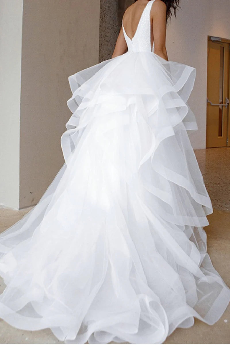 Back view of a sparkling V-neck sleeveless formal dress, showcasing its shimmer.