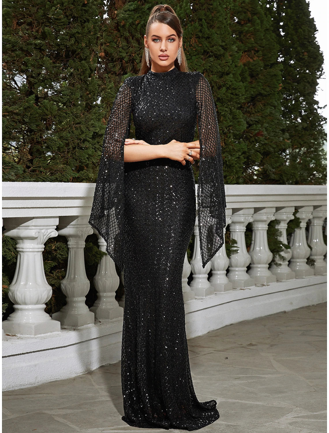 Close-up of the sequin and glitter pleat details on the evening gown.