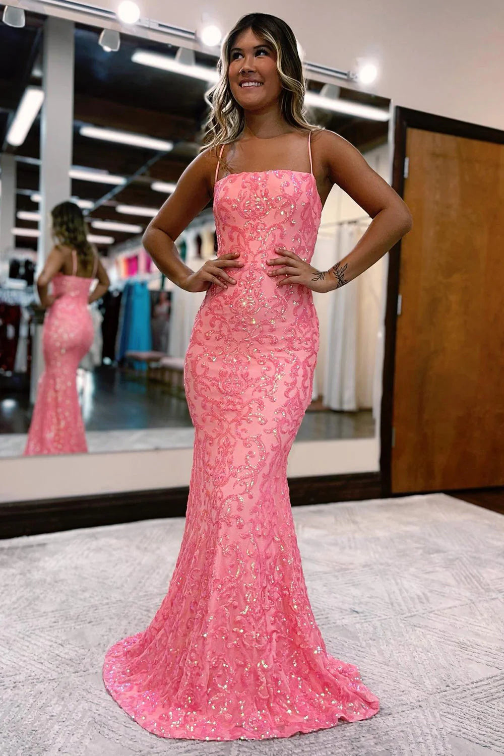 Blush pink mermaid prom dress with spaghetti straps and sequins.