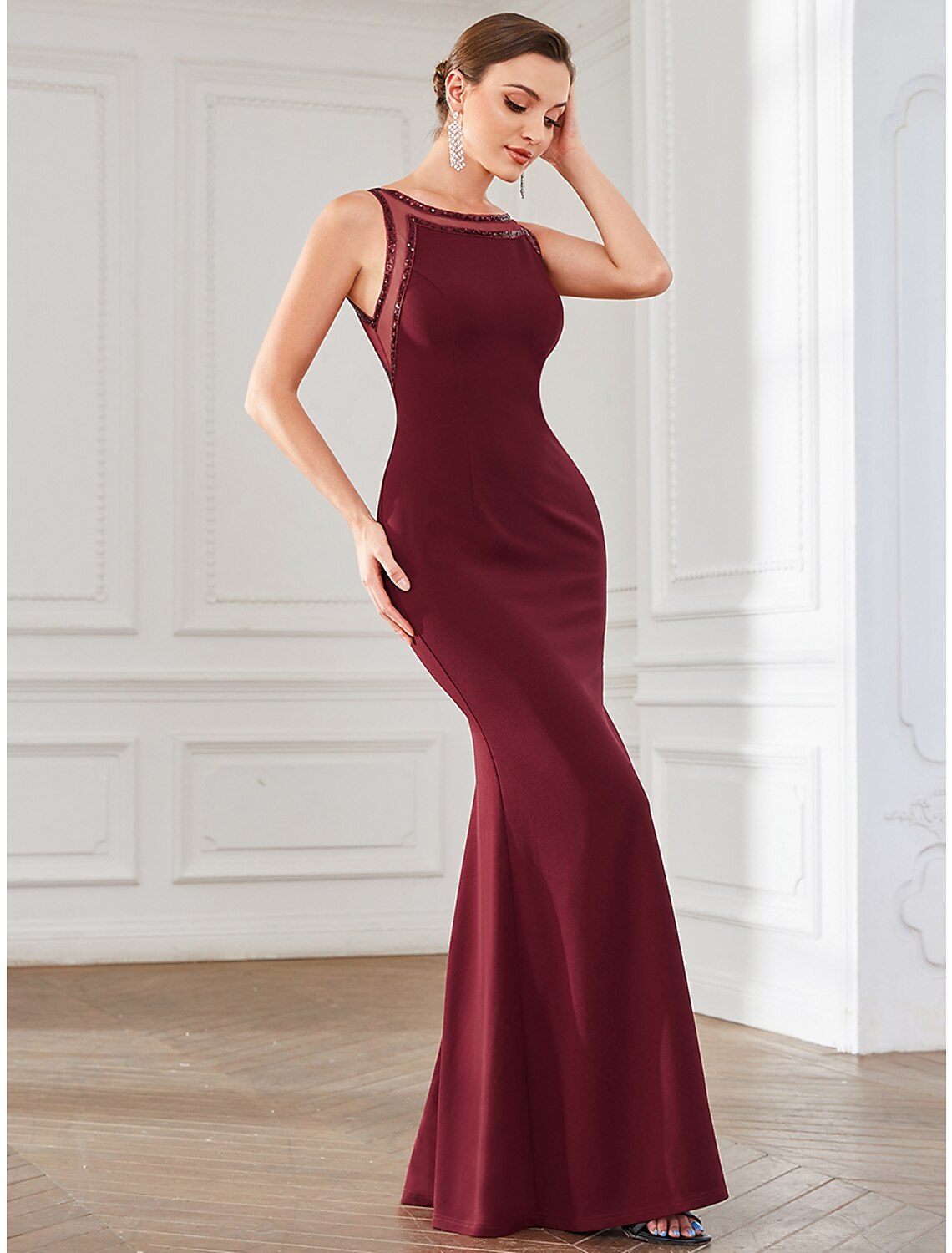 Full length view of an elegant mermaid trumpet dress with a flowing train.