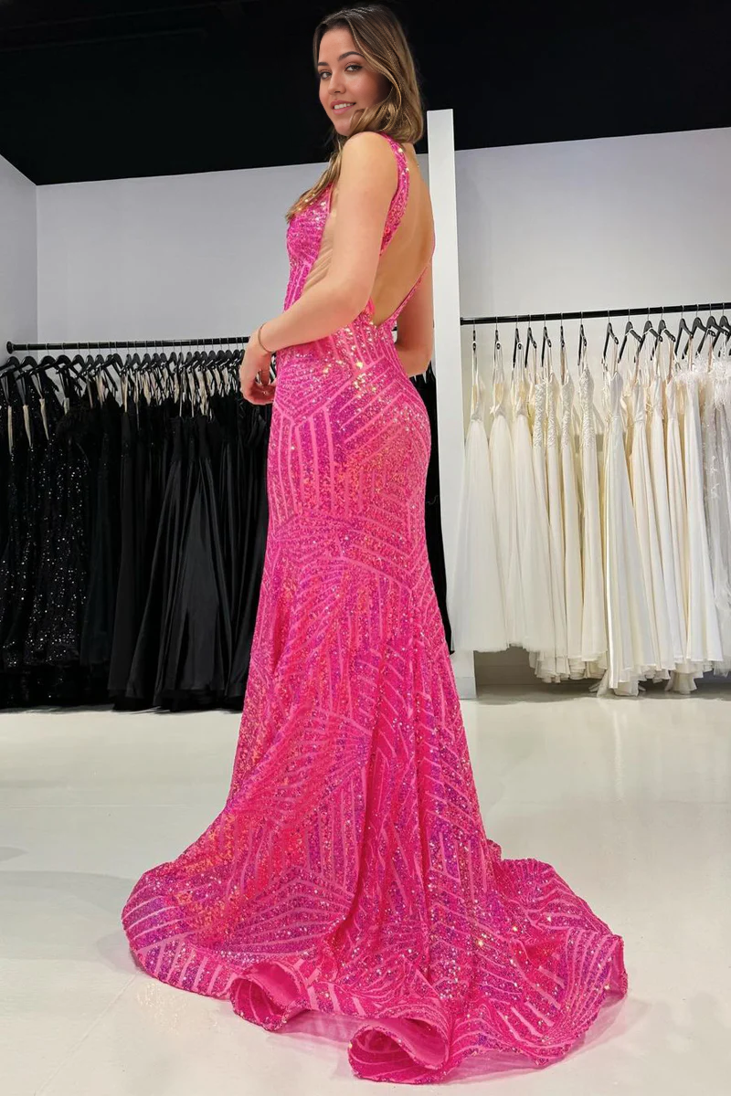 Side view of a woman wearing a pink sequined mermaid gown.