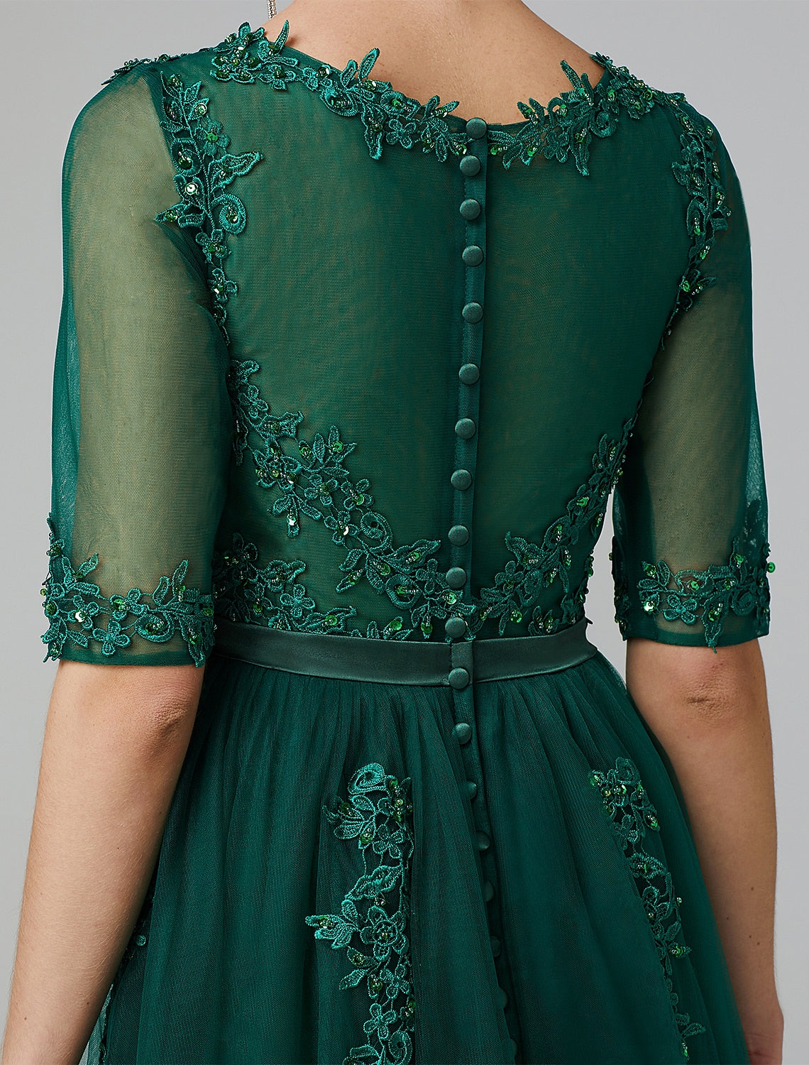 Tea length formal dress with intricate lace and sequin details.