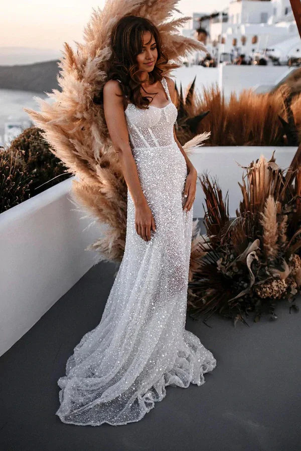 Full view of a woman wearing a sparkly A-line V-neck sequin wedding dress.