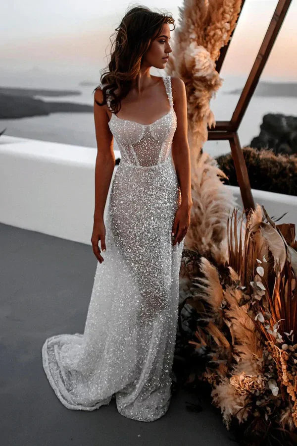 Close-up of the shimmering sequin details on the V-neck wedding gown.