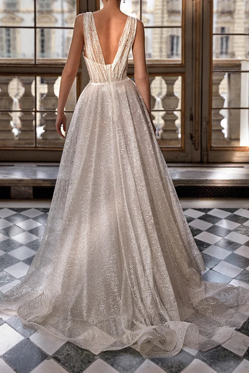 Back view of the sparkly A-line V-neck wedding dress on a model.