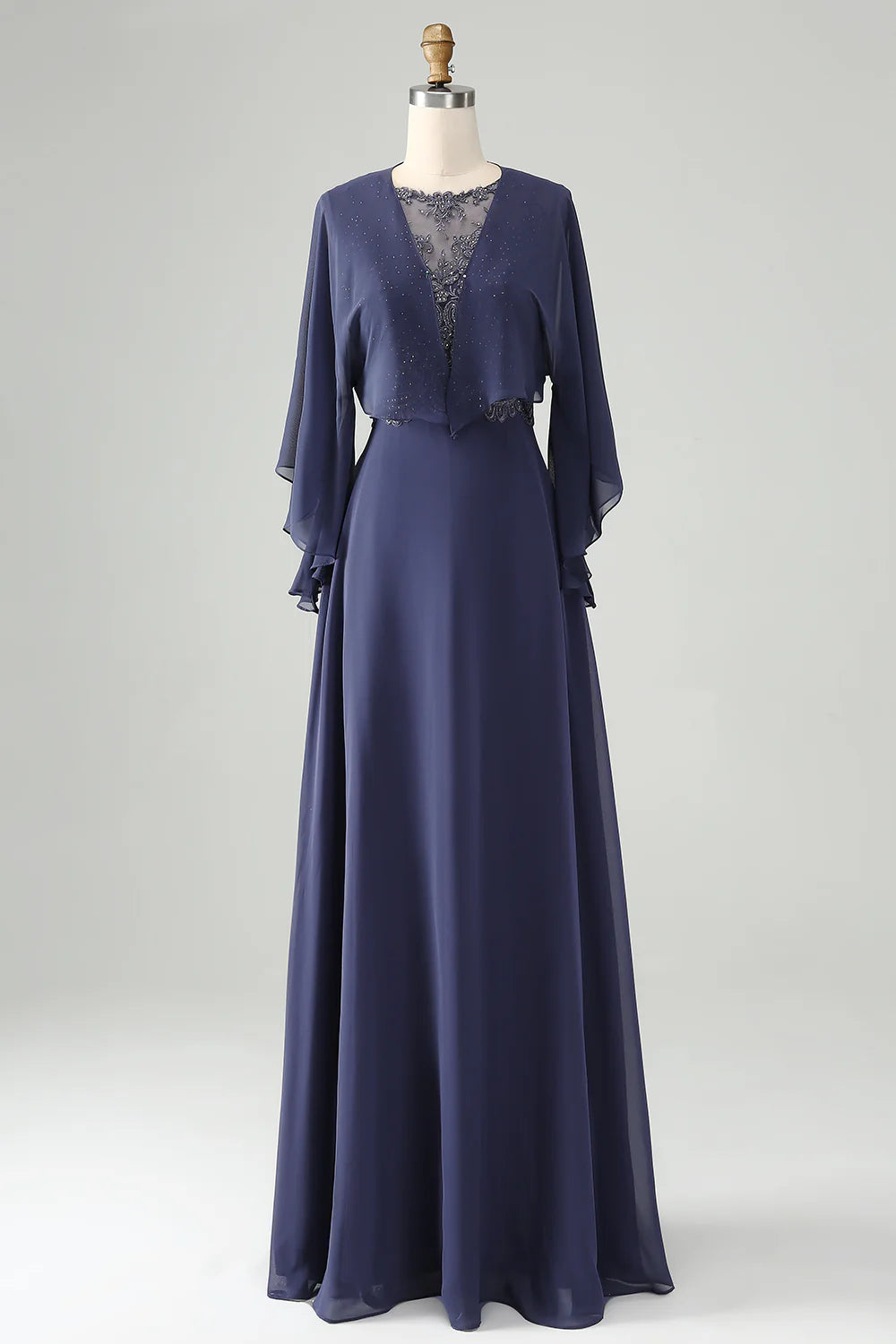 Woman wearing a sparkly beaded A-line Mother of the Bride dress with a shawl.