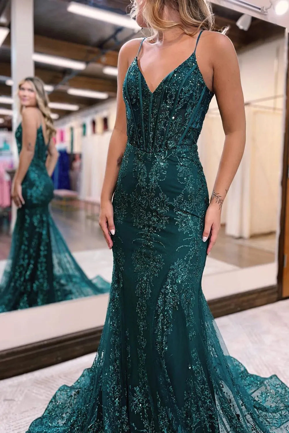 Back view of a sparkly mermaid V-neck sequin long prom dress.