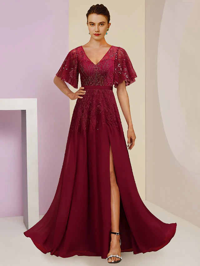 Elegant sequined V-neck sheath dress with short sleeves and split front.