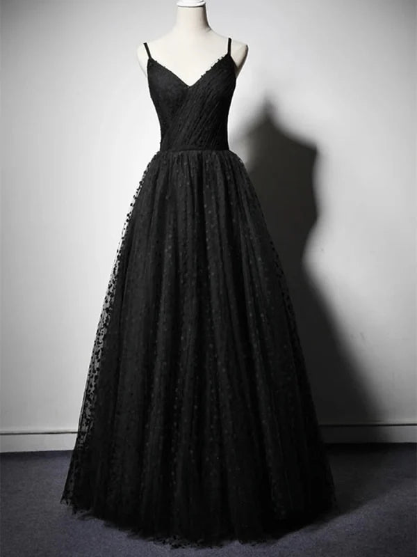 Woman wearing a spotted V-neck long prom dress with an A-line silhouette.