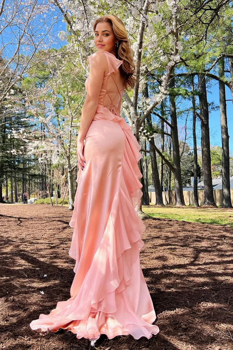 Pink chiffon prom dress with square neck, ruffle, and slit.