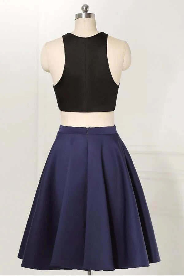 Model wearing a black two-piece sleeveless straight knee-length homecoming dress.