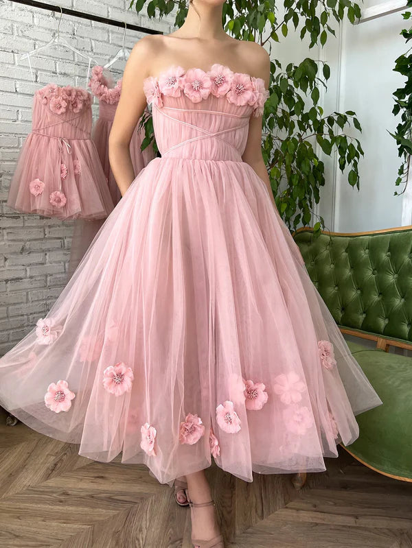 Blush strapless tea-length tulle gown with 3D floral appliqués.