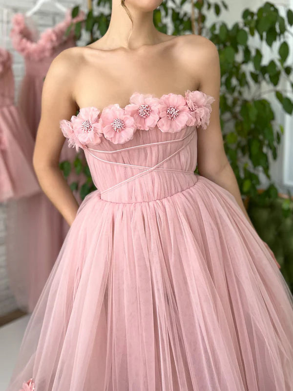 Close-up of 3D floral appliqués on blush tulle gown bodice.