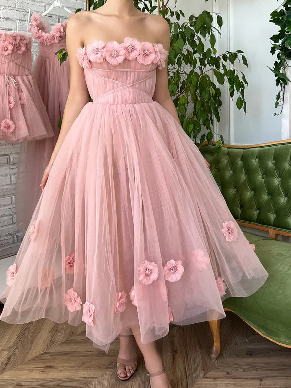 Side view of blush tea-length gown, showcasing skirt volume and floral details.