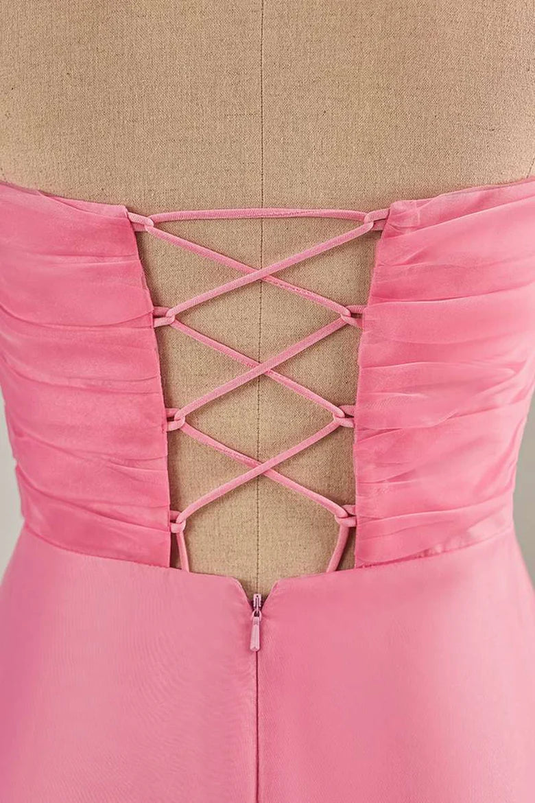 Side view of a hot pink strapless knee-length chiffon dress.