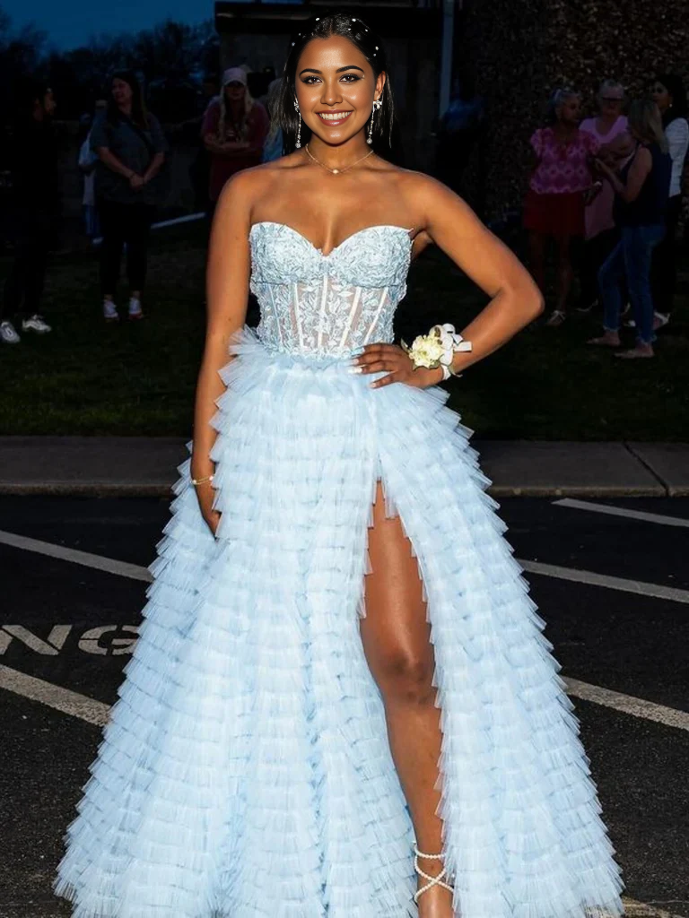 Close-up of the intricate lace and flowing ruffle on the prom dress.
