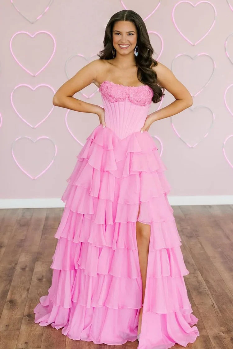 Side view of a model showcasing the high slit on a tiered ruffled formal gown.