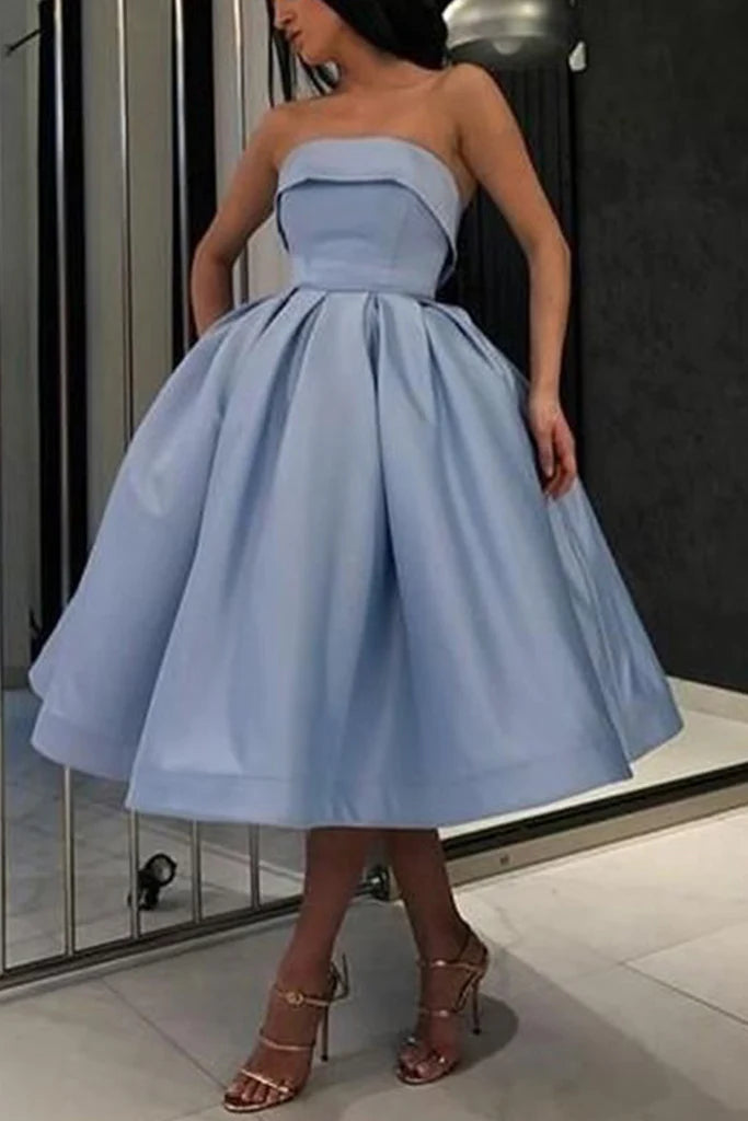 Elegant strapless A-line maxi gown in a formal setting.