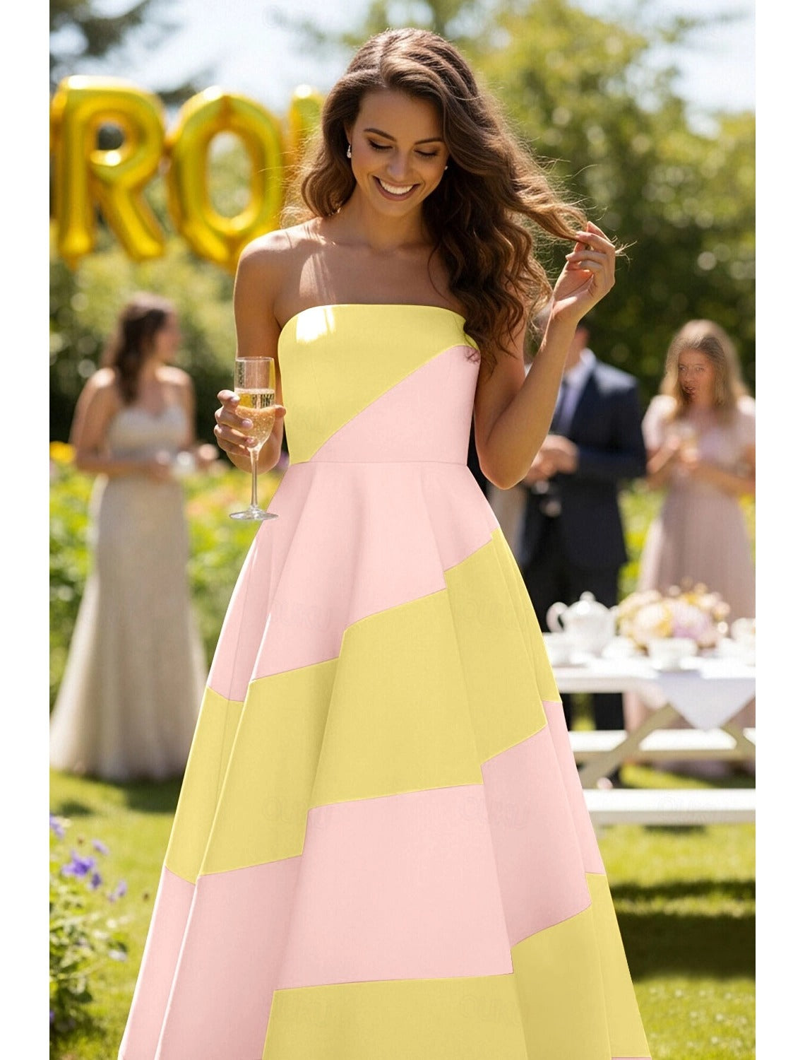 Back view of a strapless open-back formal evening gown.