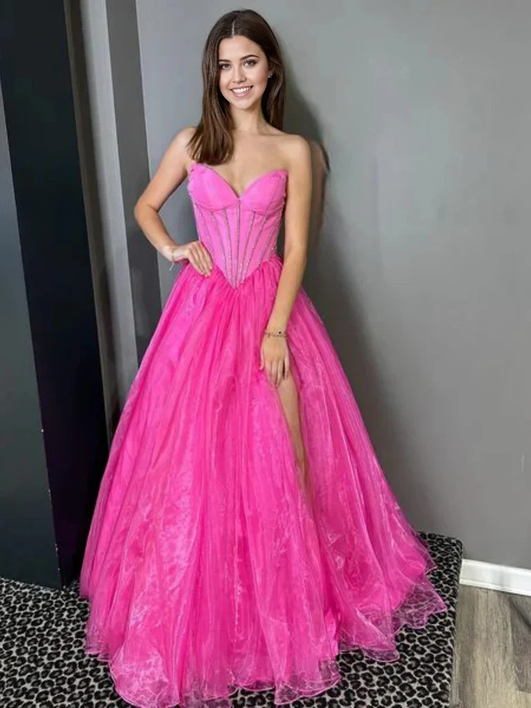 Full view of an elegant strapless A-line tulle prom dress with a high slit.
