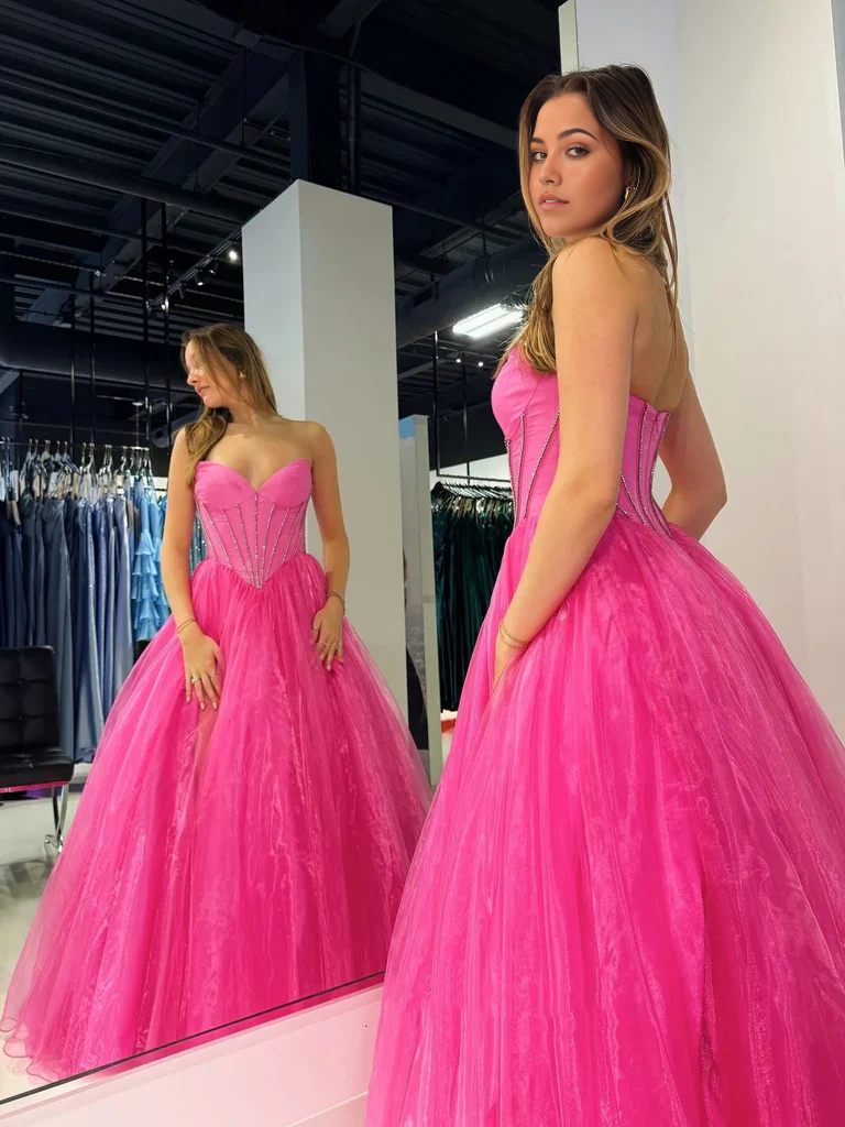 Side view of the long tulle formal dress, highlighting the flowing skirt.