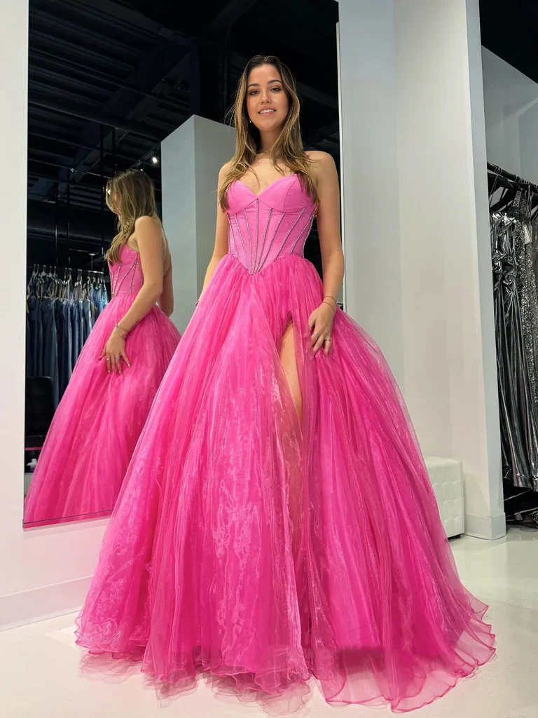 Close-up of the strapless bodice and high slit detail on the formal gown.