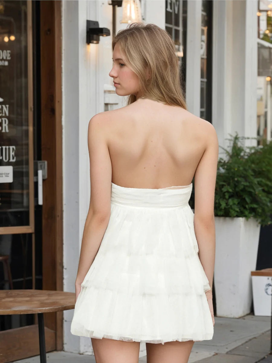 Back view of a charming strapless A-line tulle ruffle dress.
