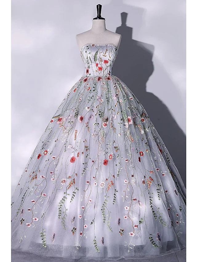 Elegant strapless ball gown with lace appliques and a floor-length skirt.