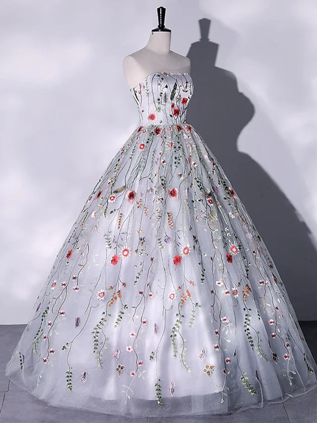Side view of a formal evening dress with a flowing floor-length silhouette and slit.