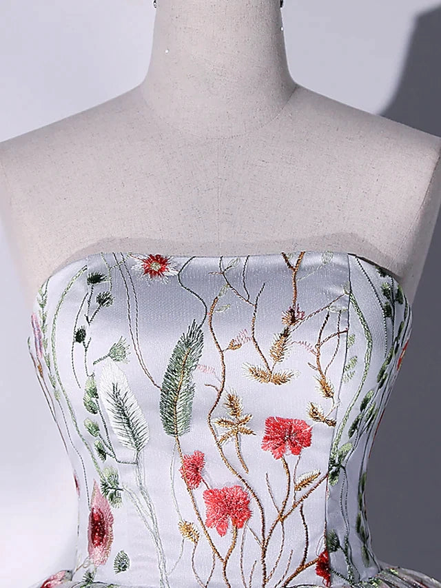 Close-up of the lace and embroidered details on a strapless ball gown.