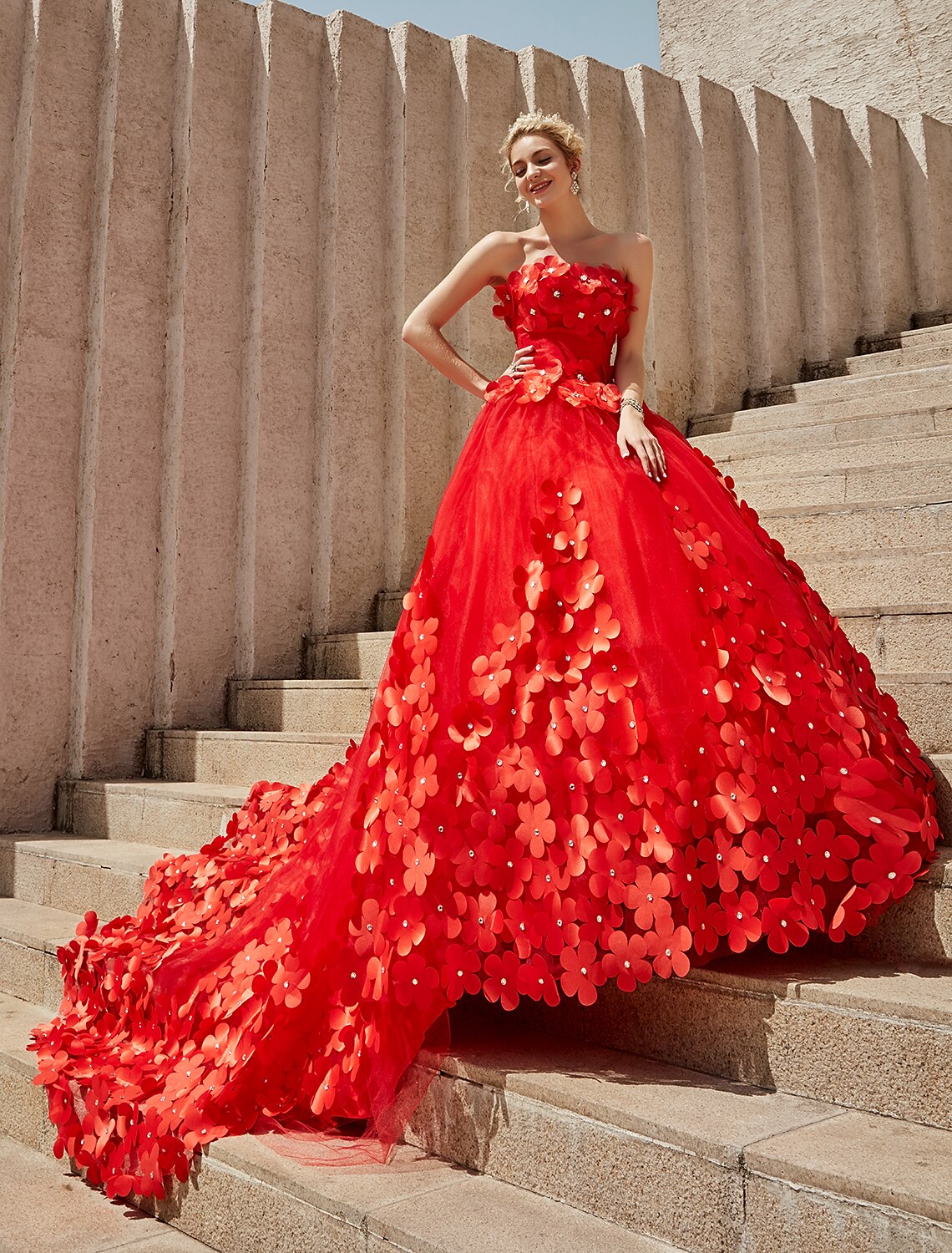 Side view of a bride wearing a strapless lace ball gown.