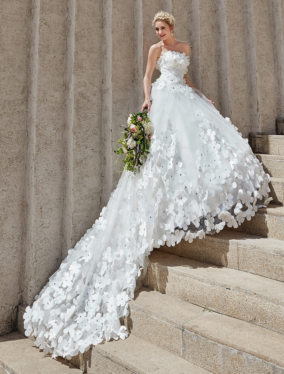 Bride posing in an elegant open back wedding dress.
