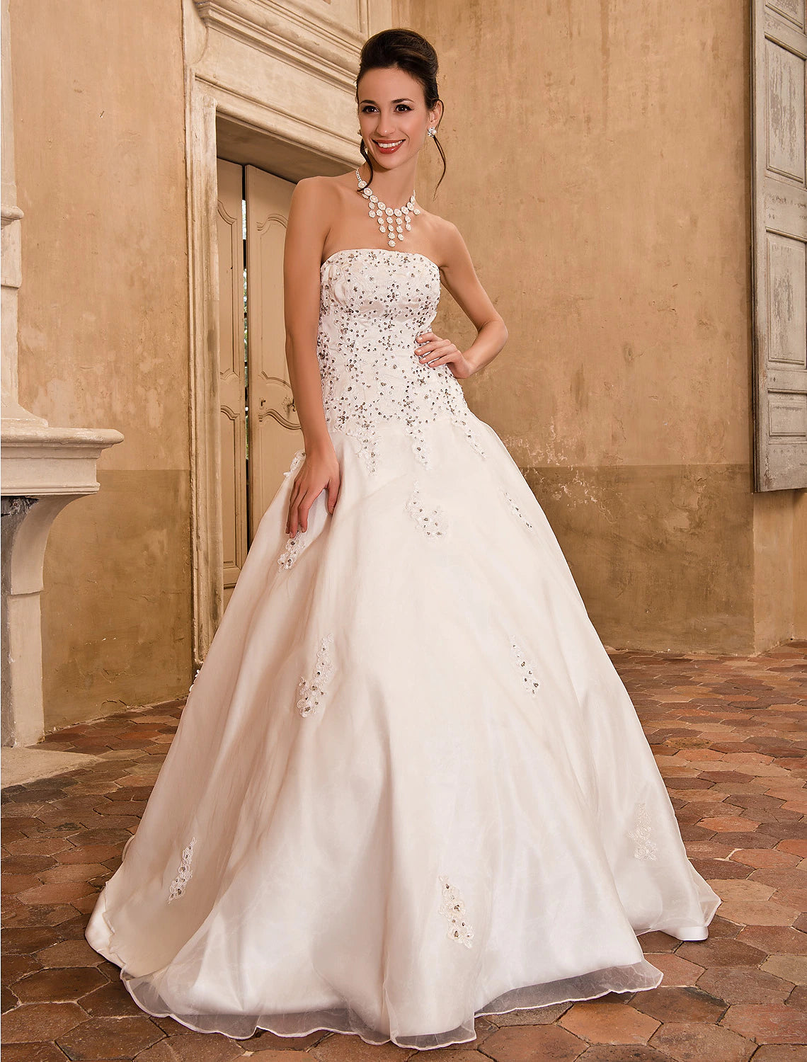 Back view of a strapless satin ball gown wedding dress with delicate appliques.