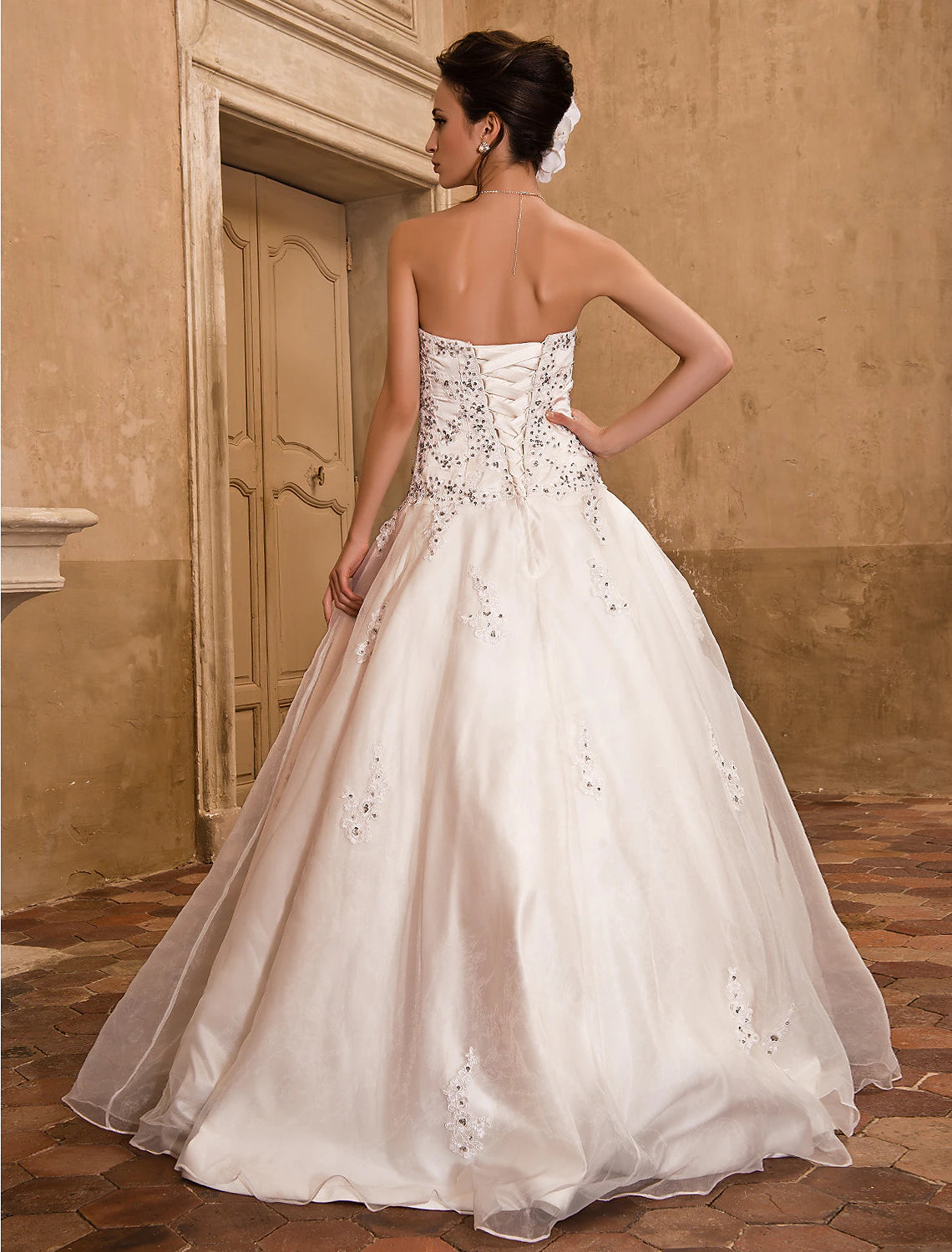 Front detail of the strapless neckline and bodice of the satin wedding dress.