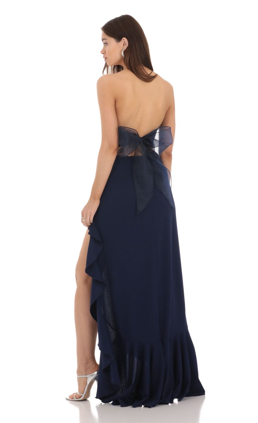 Full length view of a navy strapless maxi dress with a structured corset.