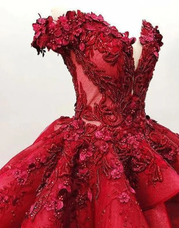 Close-up of floral appliques and beading on a ball gown quinceanera dress.