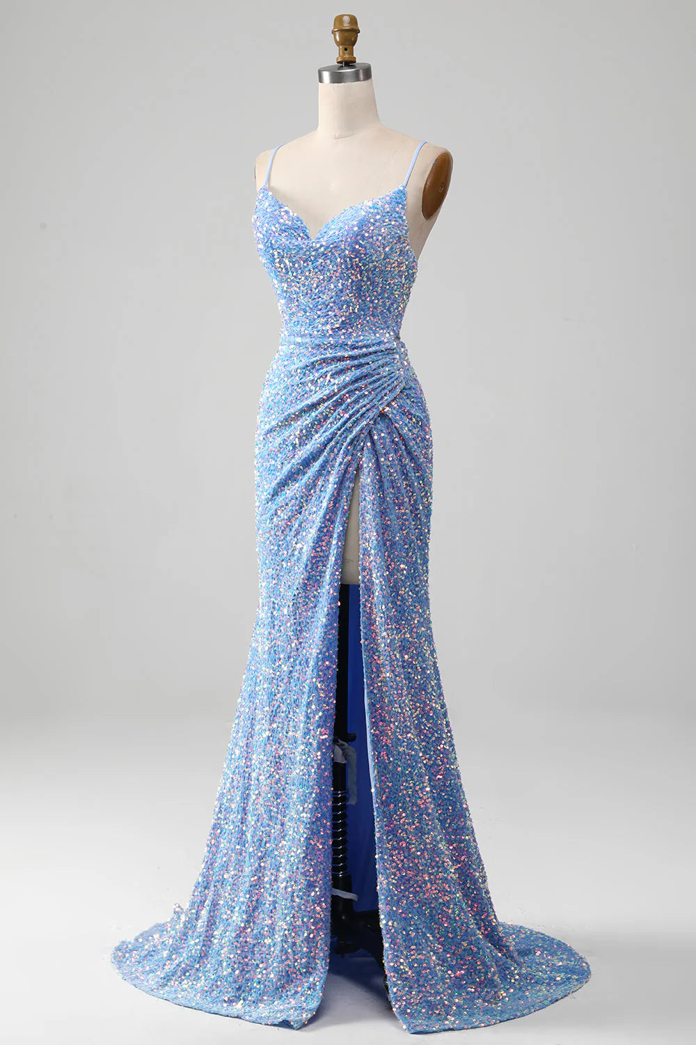 Side profile of a woman wearing a light blue mermaid dress.