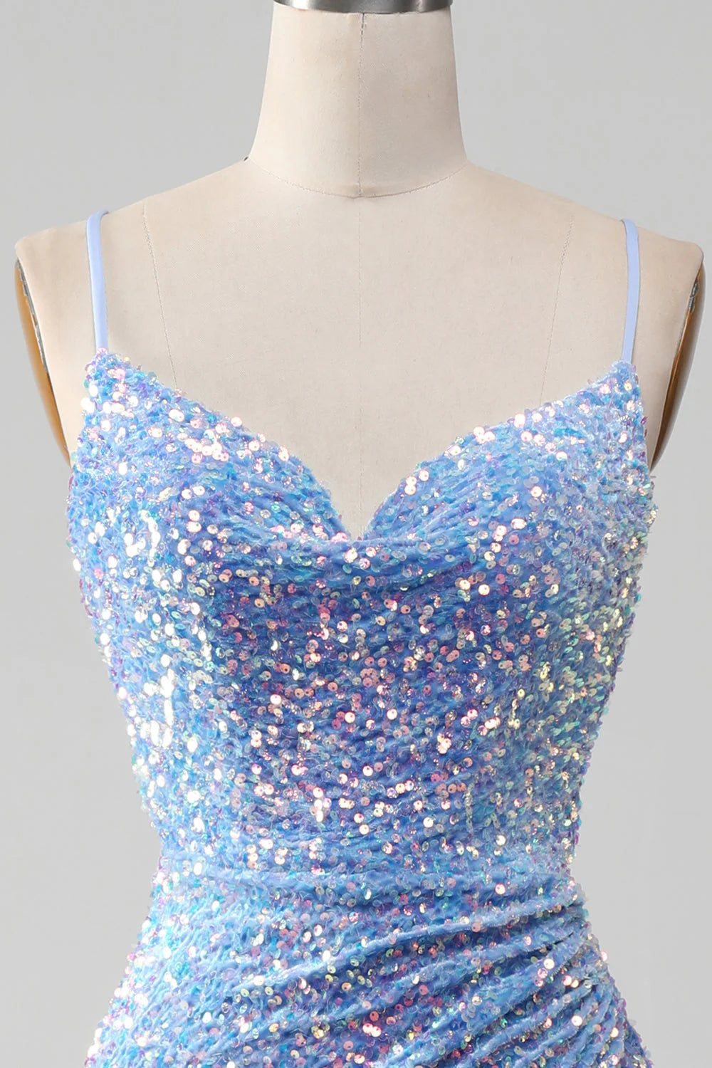 Close-up of the fabric and slit detail on the light blue dress.