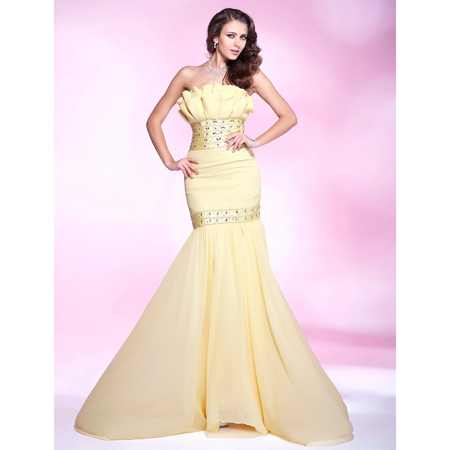 Elegant strapless mermaid evening dress with beading and ruffles.