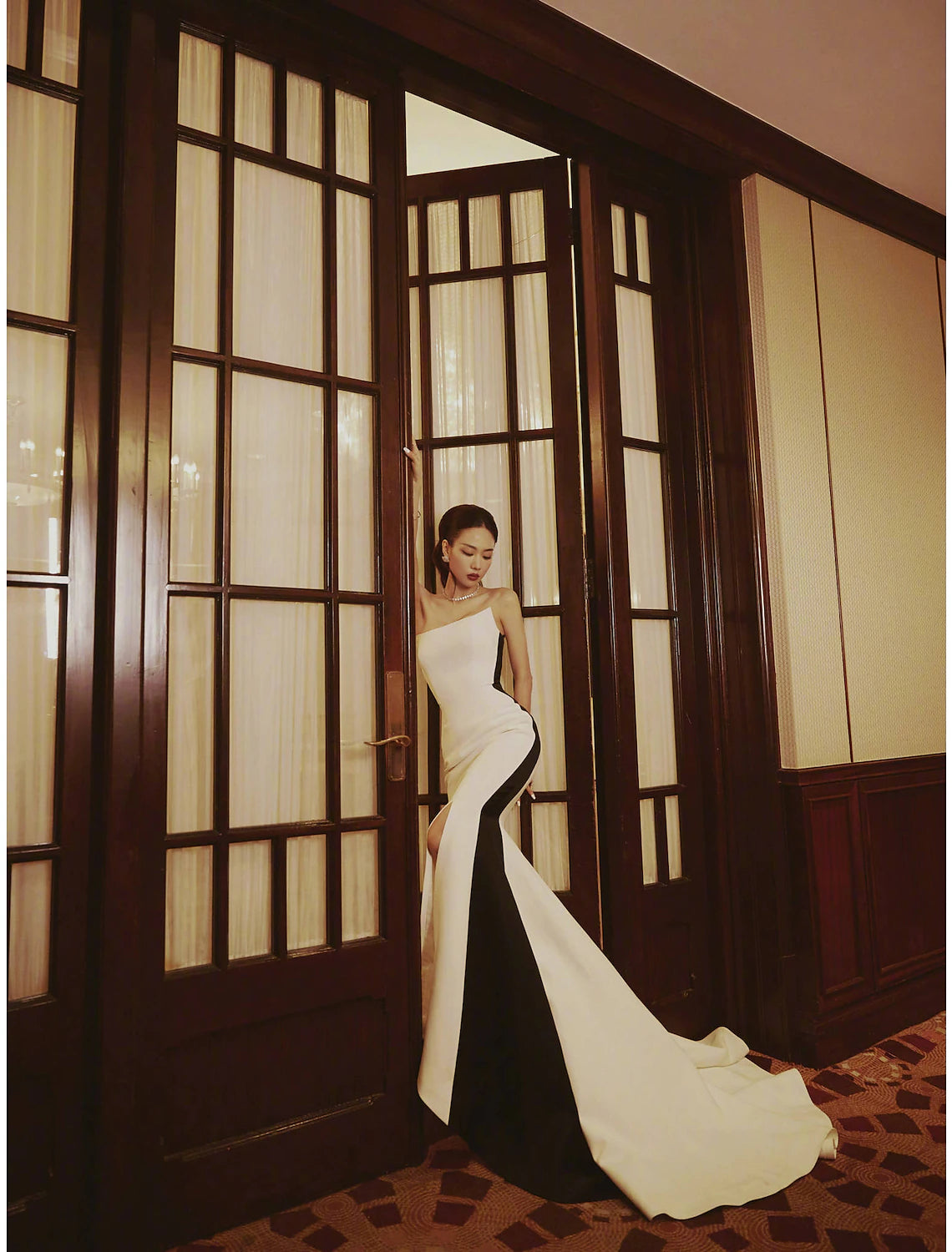 Elegant strapless mermaid evening gown with color block design and high slit.
