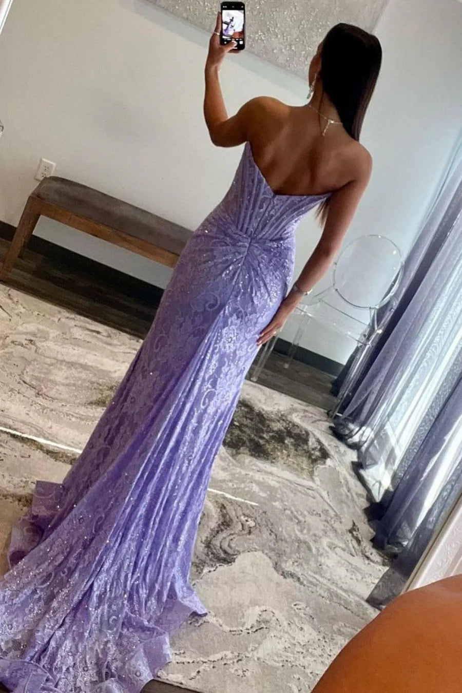 Back view of a mermaid prom dress showing the sweep train and lace.