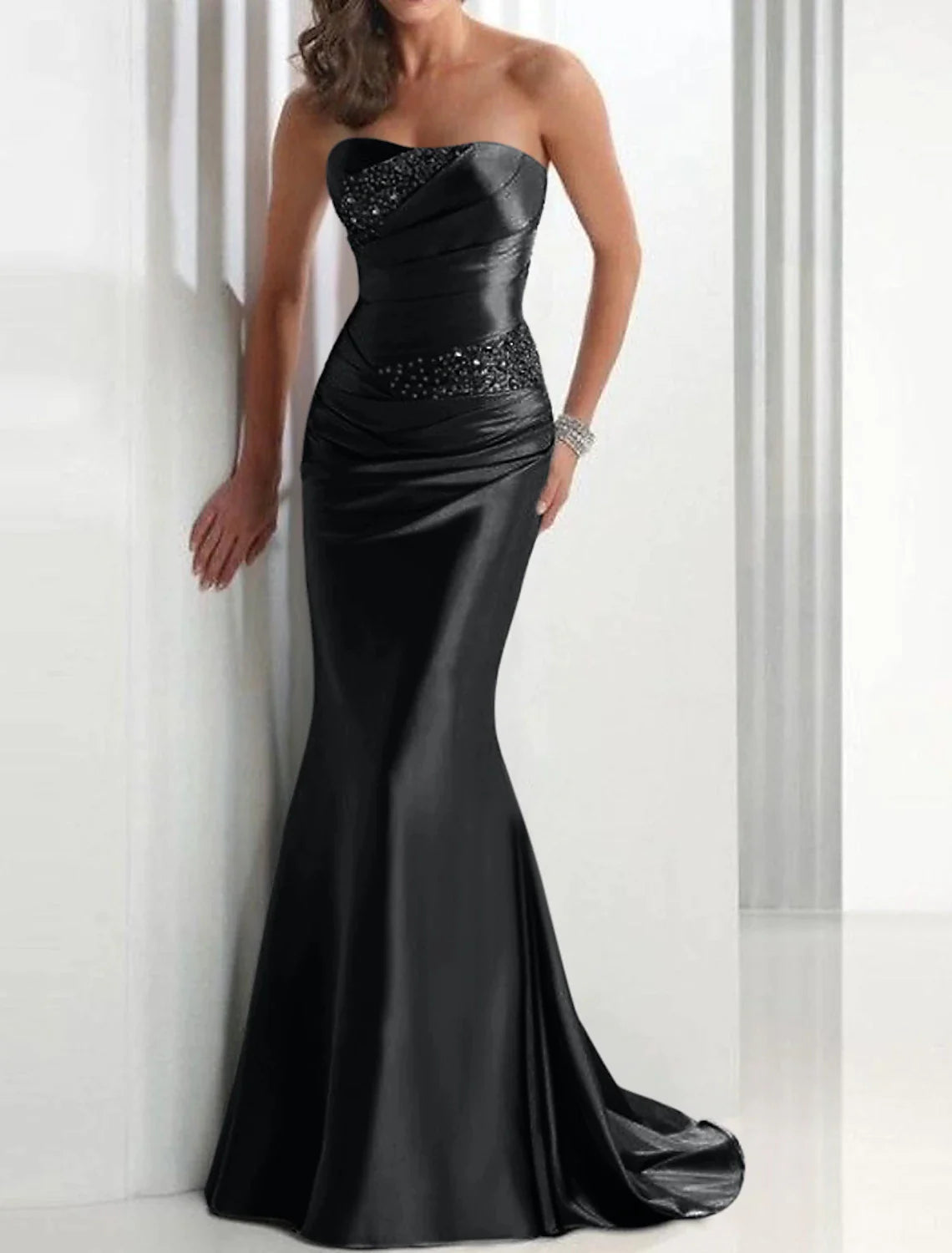 Close-up of crystal embellishments on the elegant strapless mermaid satin gown.