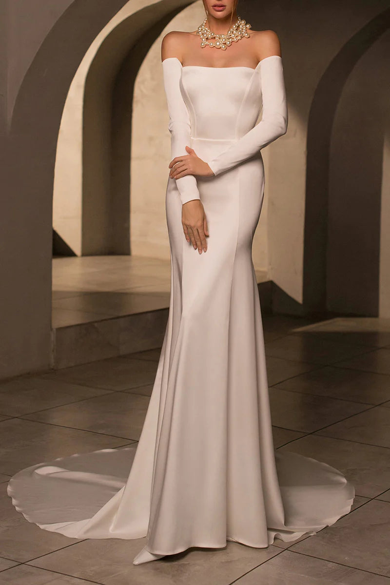 Back view of a mermaid satin wedding dress, showcasing the chapel train.